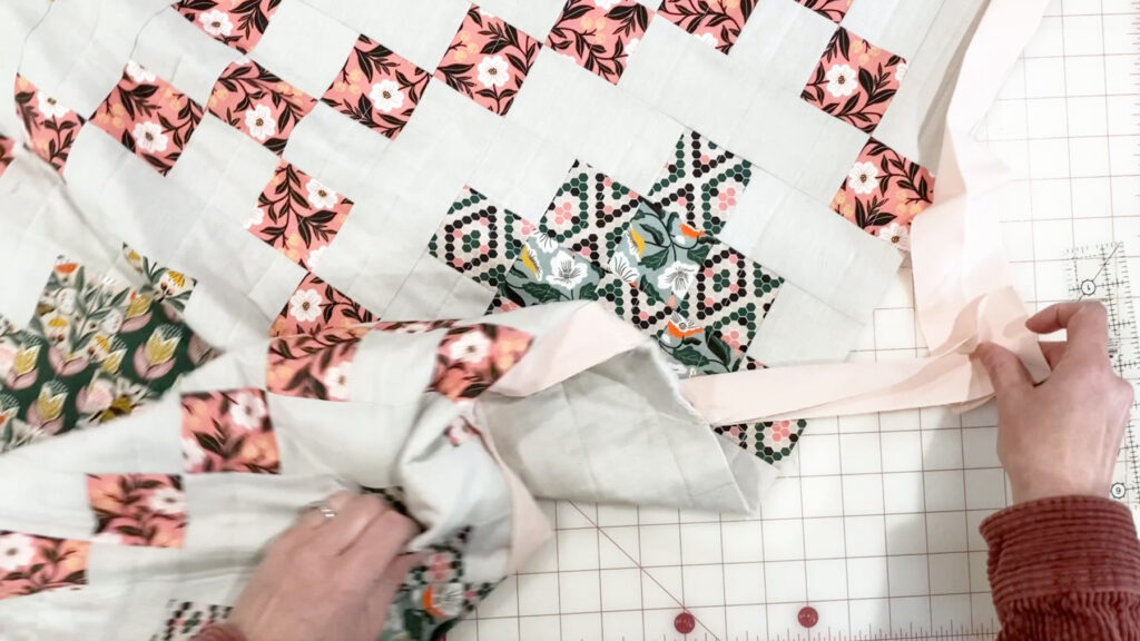 Pinning the binding ends together at a right angle.