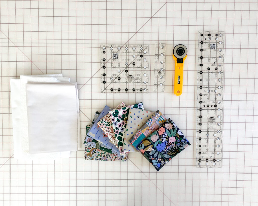 Supplies for sewing the Heart Pillow Pattern – background fabric, batting, and print scraps