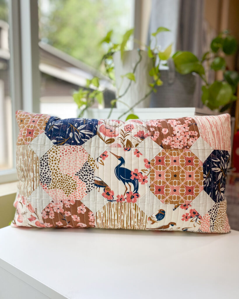 Honeycomb Pillow sewn with Enchanted fabric collection by Heather Dutton for Cloud9 Fabrics, featuring fussy cut bird prints