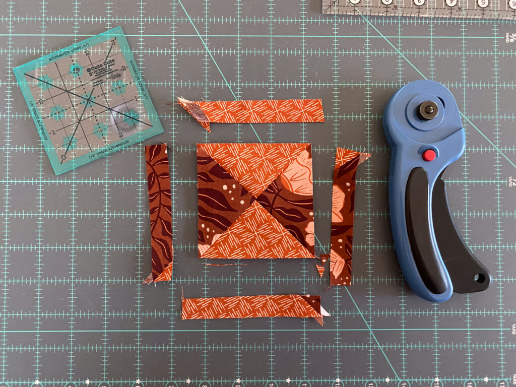 Trimming quarter square triangle for Crossroads – Moda Blockheads quilt block detail