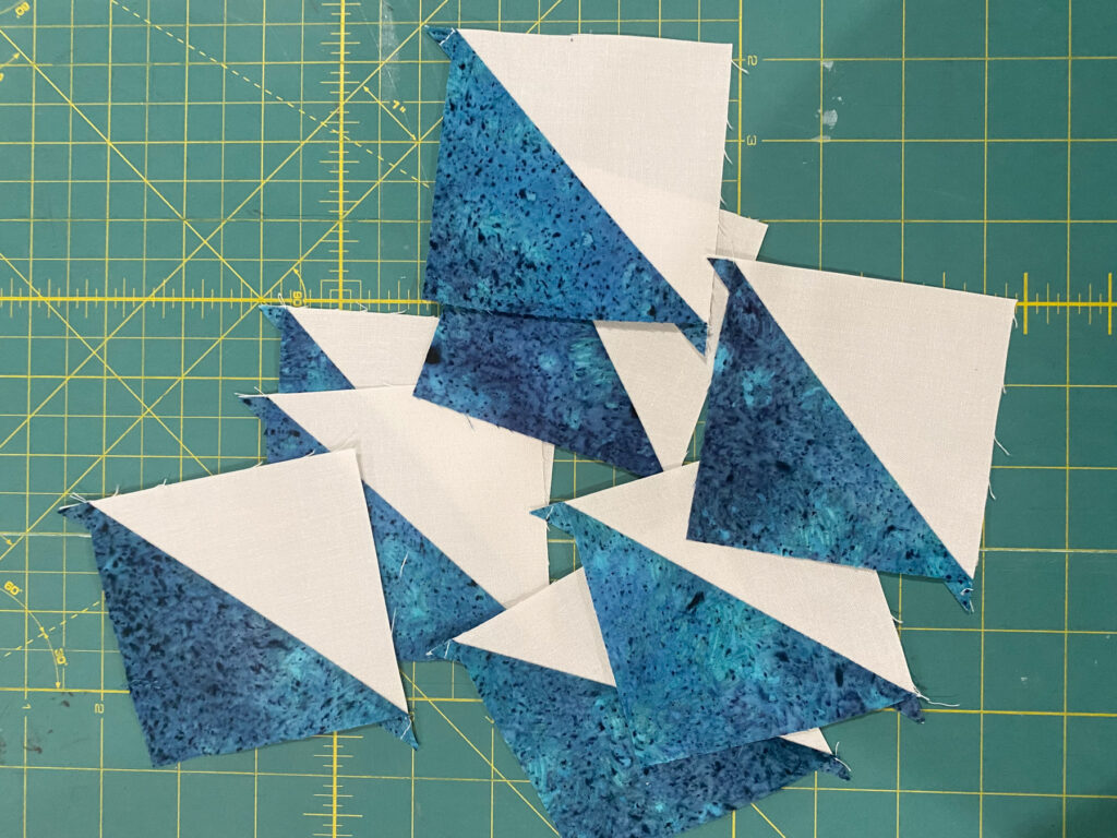 Half-square triangles made using the 8-at-a-time method for Moda Blockheads 6 Bellissimo Star block