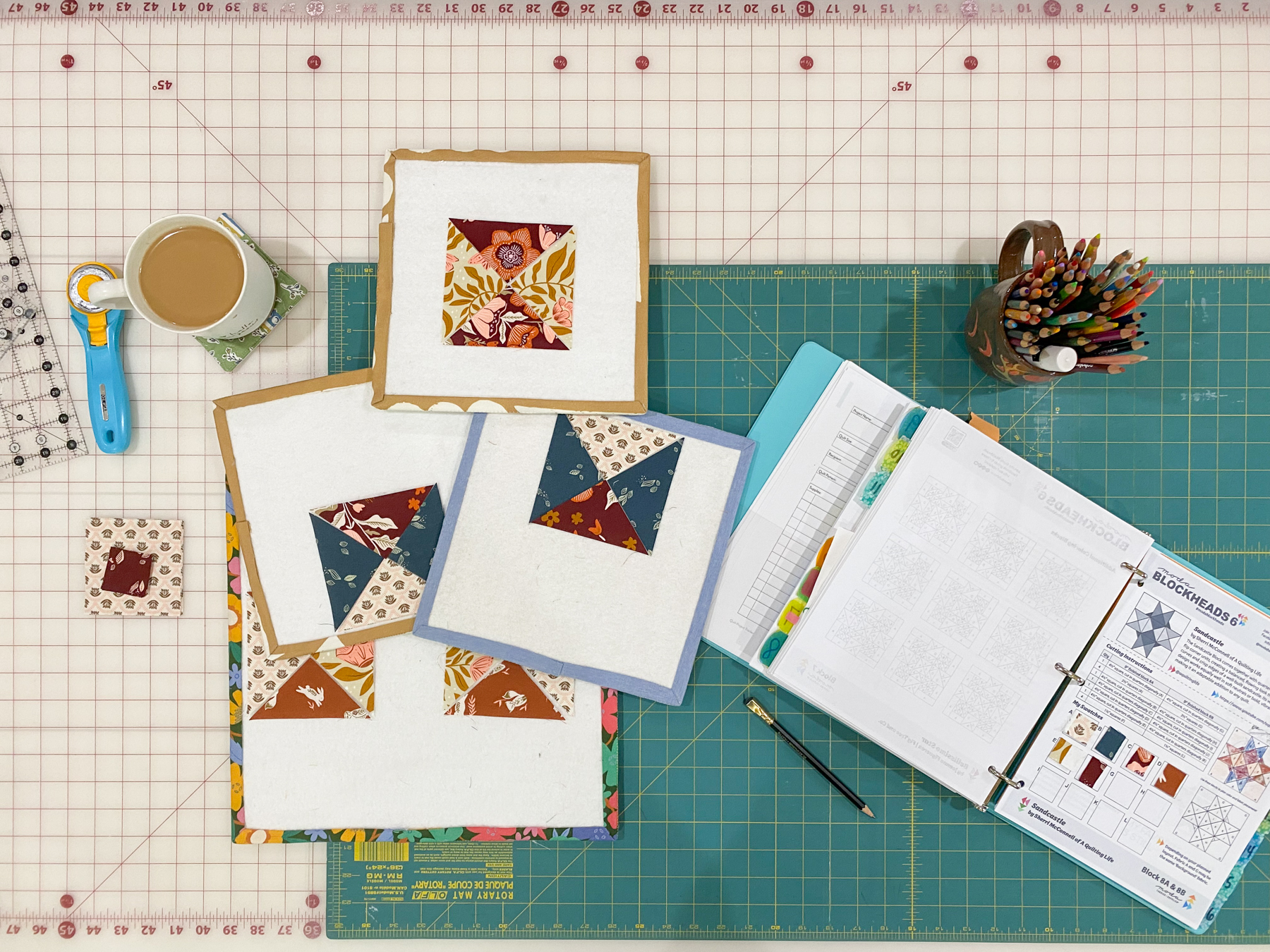 Quarter-square triangle units for Sandcastle block laid out on design boards to align background fabric direction