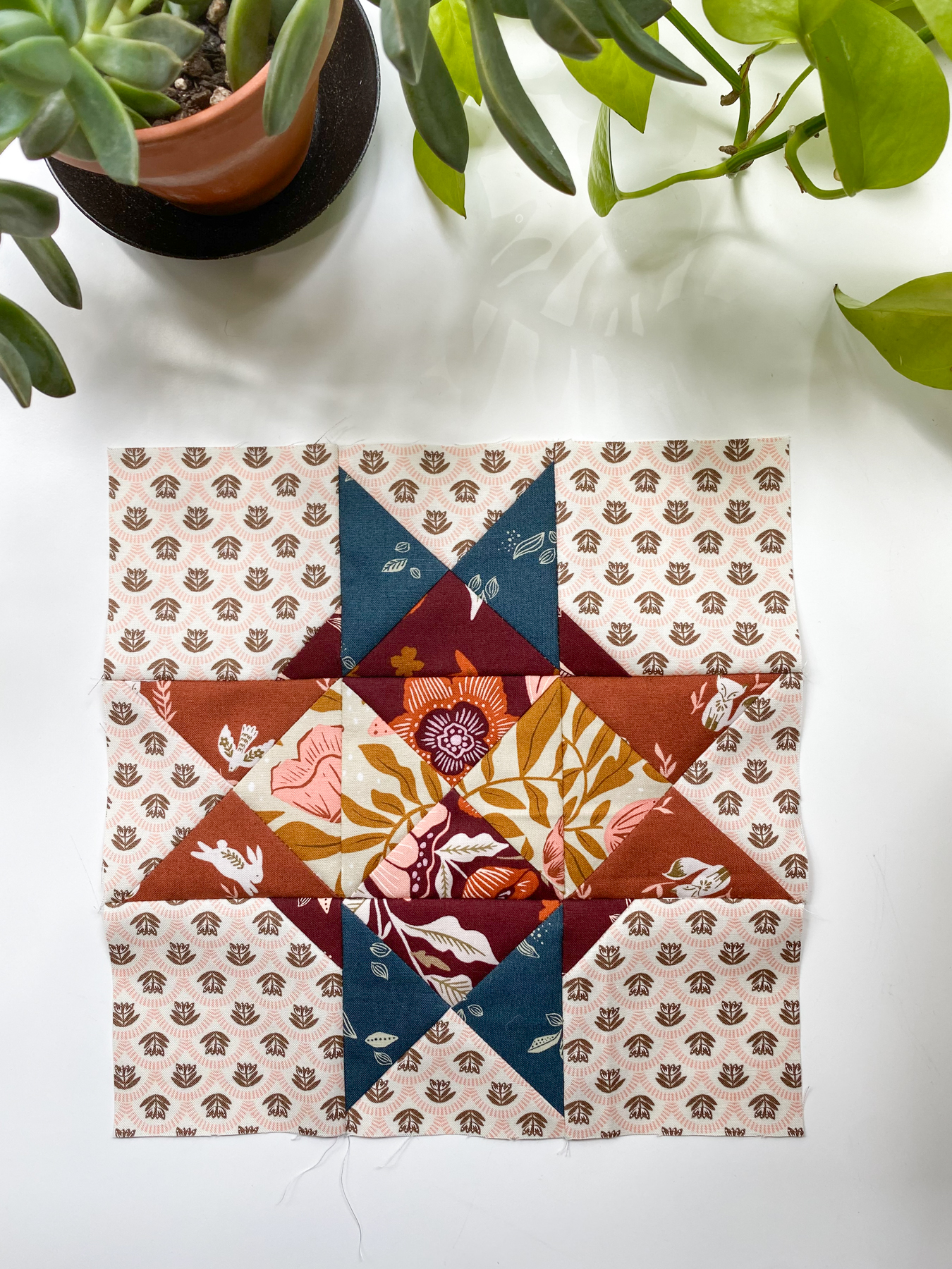 Sandcastle block from Moda Blockheads 6 designed by Sherri McConnell, featuring quarter-square triangles and blue and brown star points