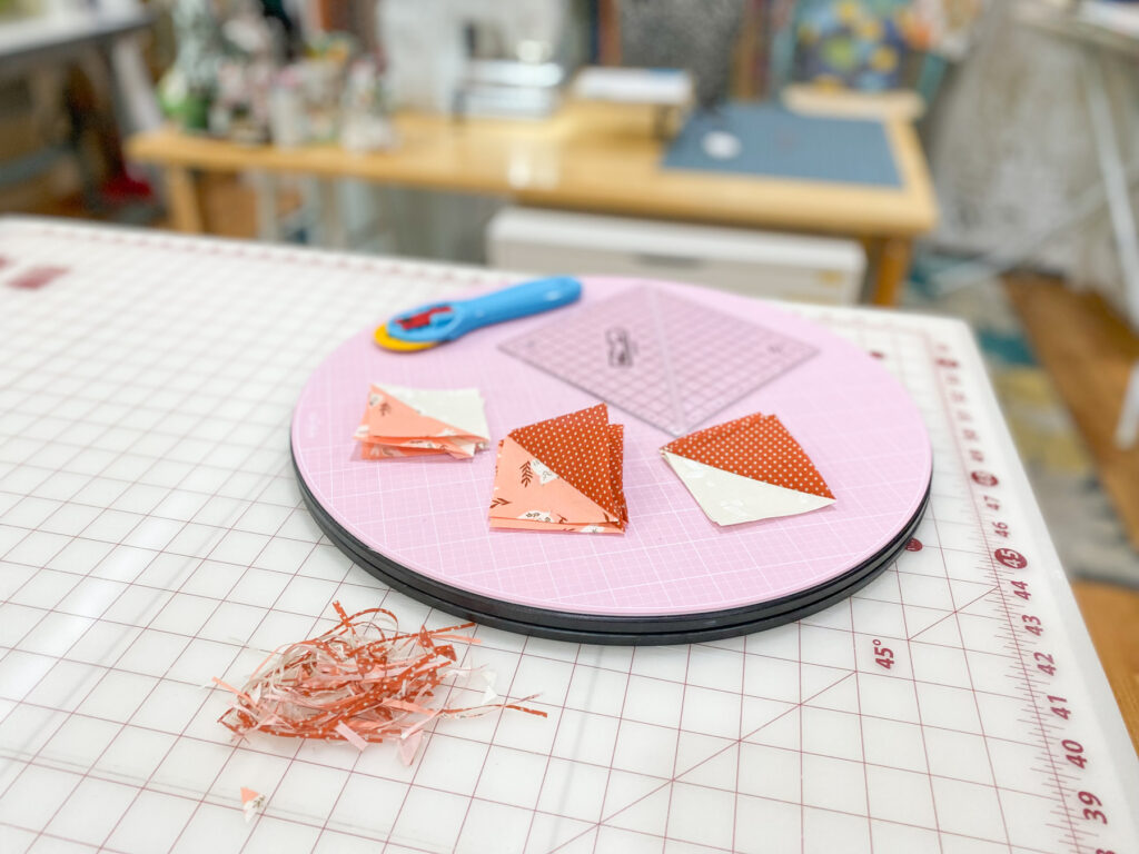 Half-square triangle quilt block from Moda Blockheads 6 trimmed with Bloc-Loc ruler for precision.