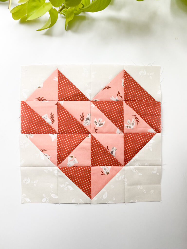 Whole Hearted quilt block from Moda Blockheads 6 featuring golden and cream half-square triangles.