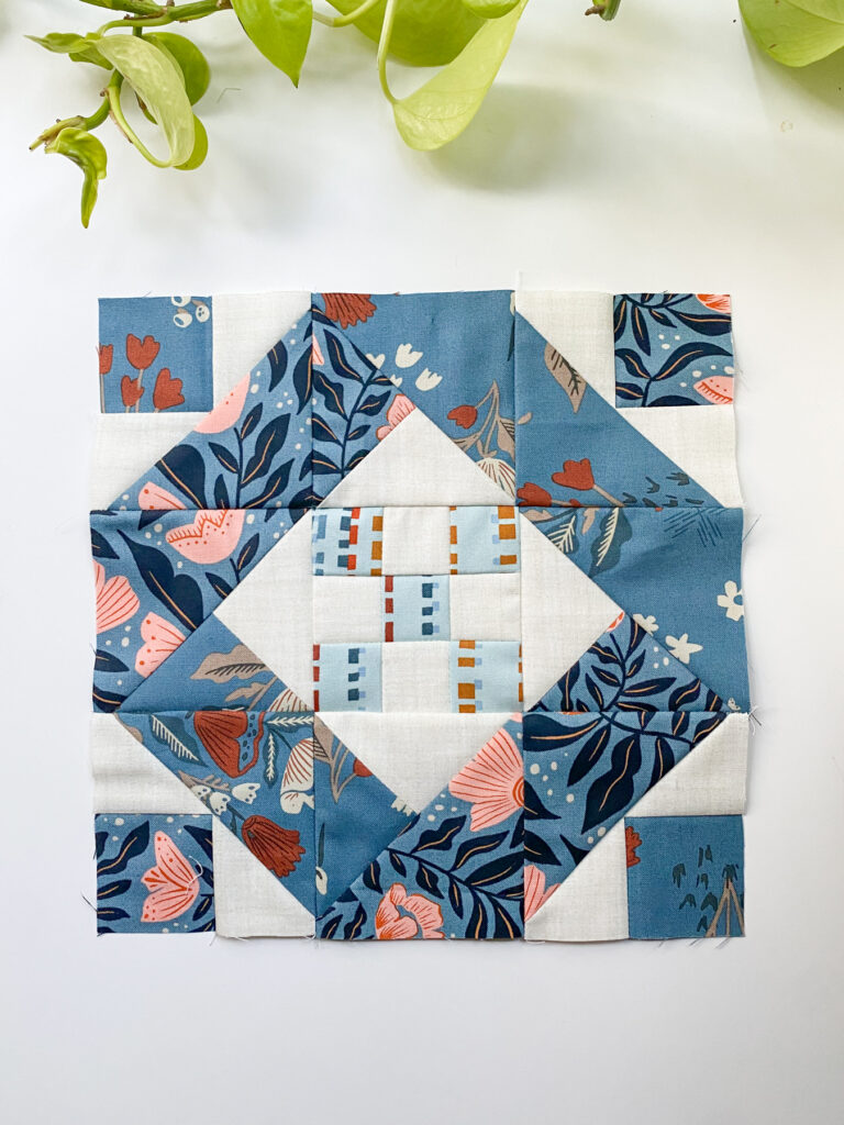 Moda Blockheads 6 Lucky Charm block made with large-scale blue florals and soft vintage prints.