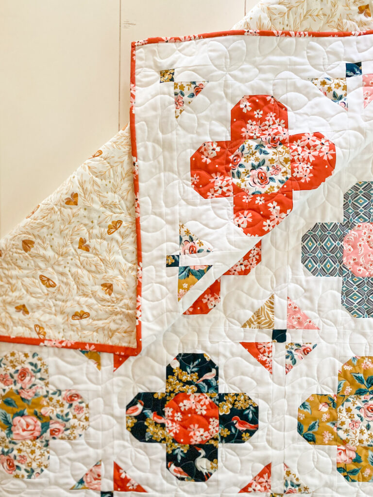 Triplet pantograph longarm quilting on Gem Blossom quilt made with Flower Garden fabric
