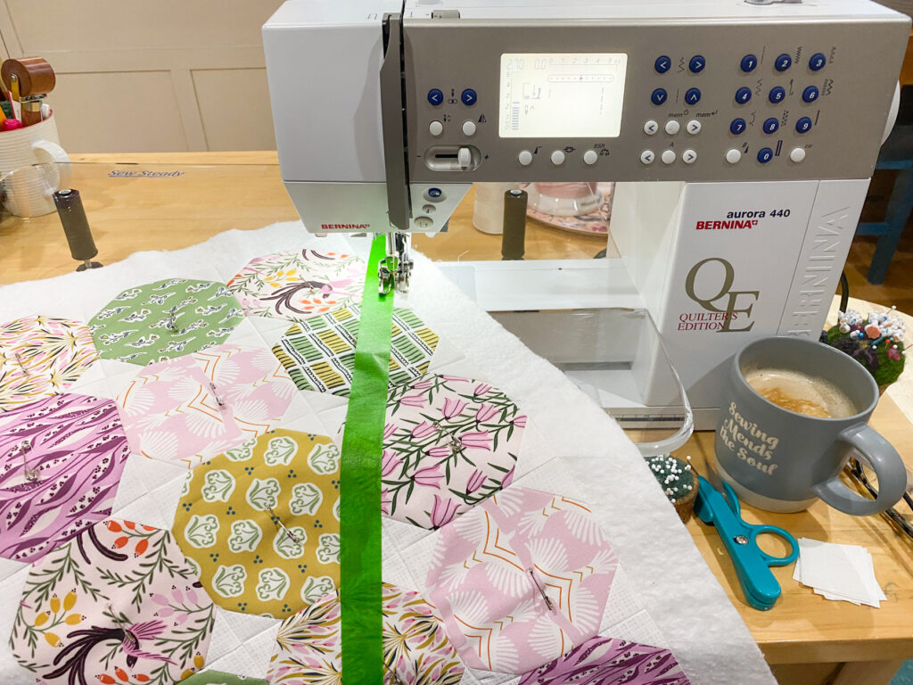 Using a walking foot to sew straight lines along painter’s tape on pillow top
