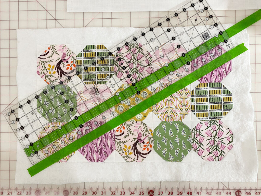 Ruler used to measure 2 inch spacing for straight line quilting on pillow top using masking tape